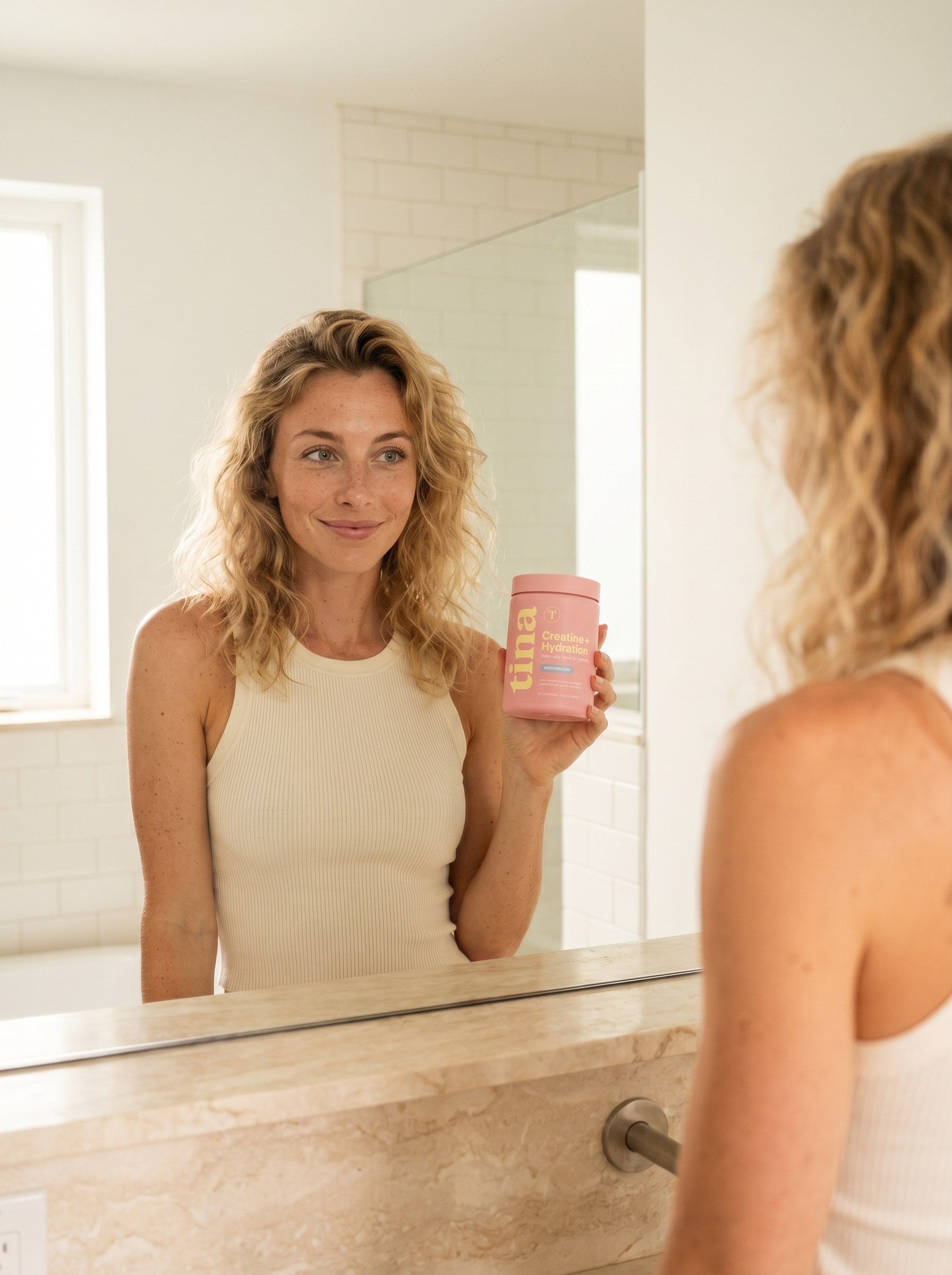 Energized morning with TINA — same woman, glowing and radiant, holding the pastel pink TINA jar