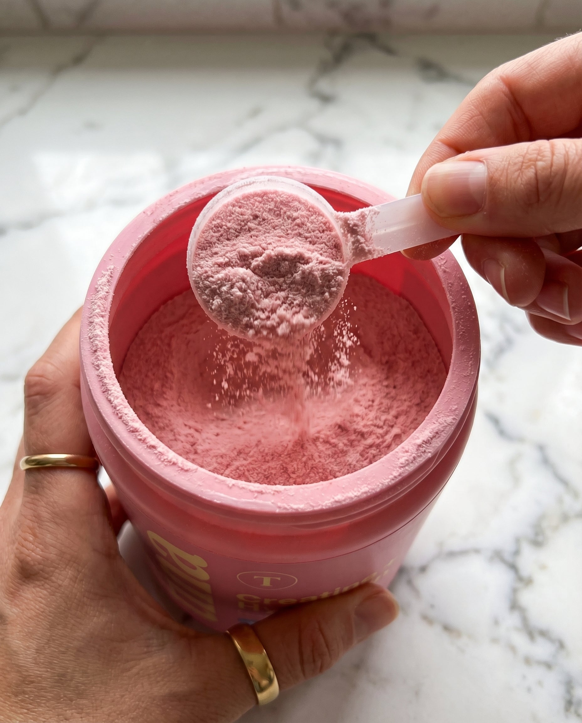 Close-up of hand scooping TINA powder
